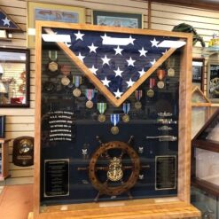 RECTANGLE WITH SHIPS WHEEL AND COIN RACK ON BASE